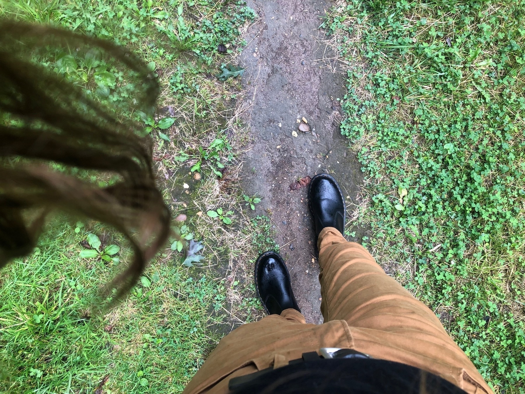 From Hunter's POV: hair hanging down, a pair of rain boots, a footpath underfoot.
